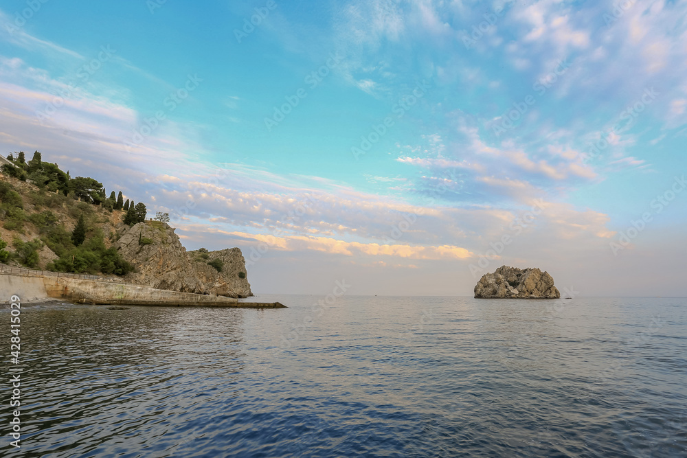 Rocks in the Crimea at sunset. Beautiful sunset on the sea. Crimean landscape. Evening on the Black Sea. Adalara rocks in Gurzuf.
