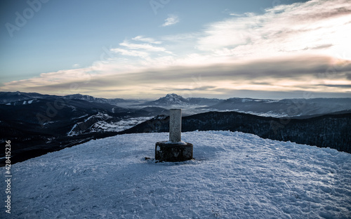Cross on the top of the mountain in winter