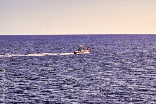 Heraklion Crete, Greece, September 14, 2017: Young couple sailing on a boat in mediterranean sea. Seascape horizon and traveling concept during summer © Arpan