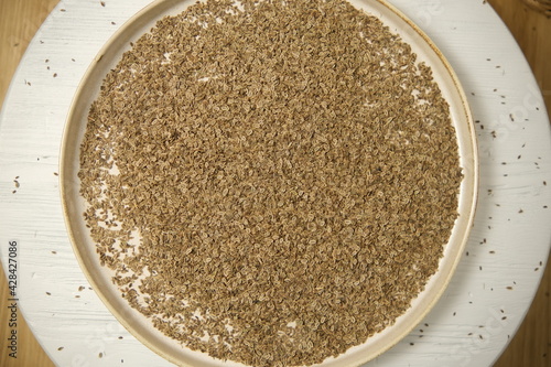 Dill seeds. Medicinal herbs. Aromatic seeds. Top view. Soft focus. On a wooden table.