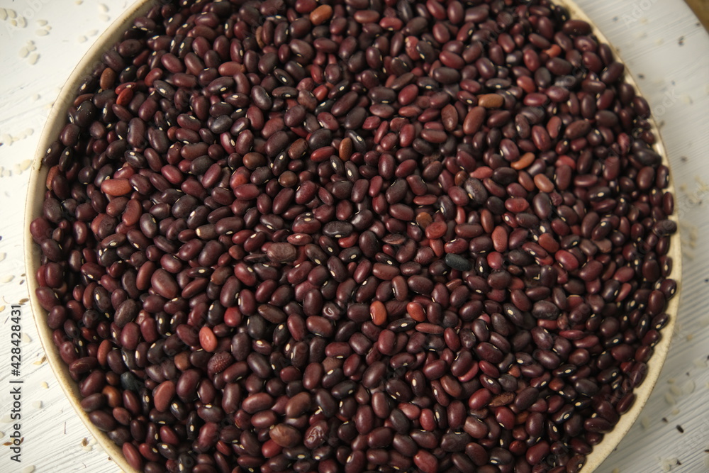 Pile Of Raw Red Organic Kidney Beans Rotating Top view. Soft focus. On a wooden table. Pile Of Raw Red Organic Kidney Beans Rotating Top view. Soft focus. On a wooden table.