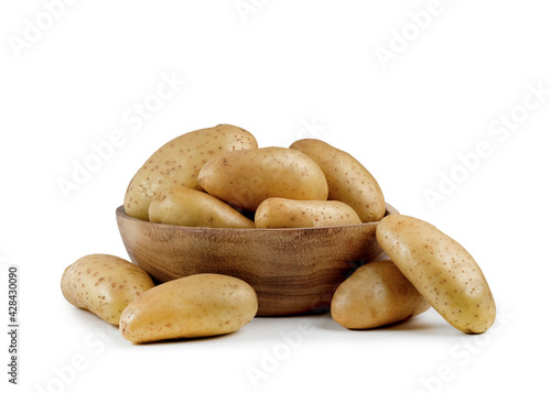 Pile of fresh new potatoes in wooden bowl isolated on white background.