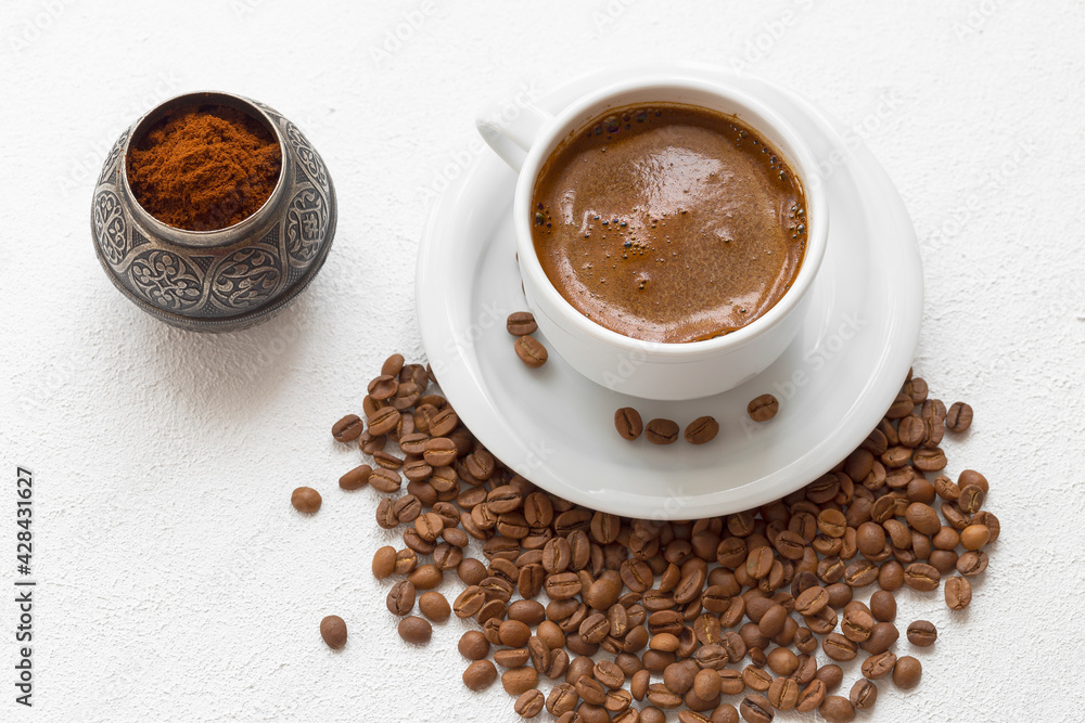 Coffee and coffee grains. The coffee grains are ground in the coffee grinder. Coffee and coffee grains. The coffee grains are ground in the coffee grinder.