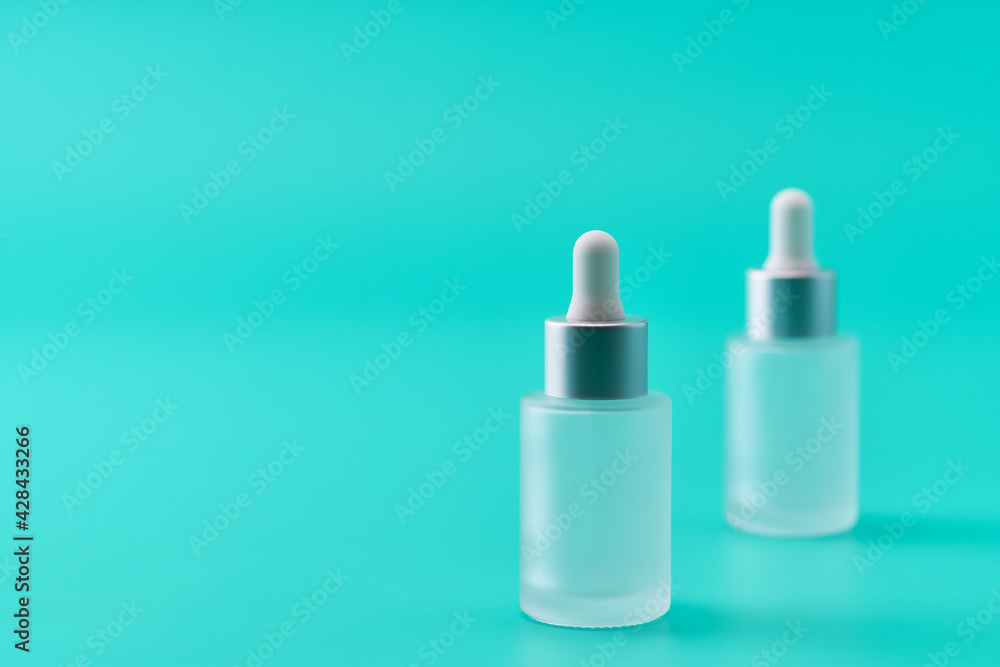 medical skin care, bottle for serum, micellar toner on blue background,selective focus. medical skin care, bottle for serum, micellar toner on blue background,selective focus.
