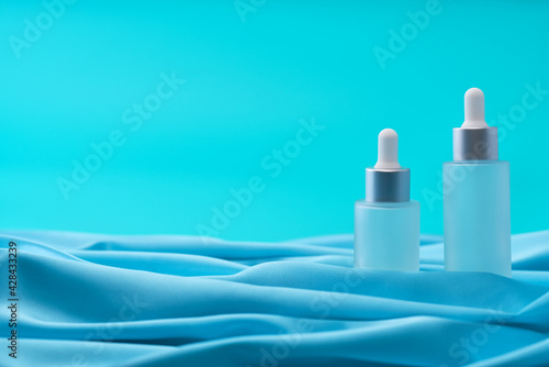 medical skin care, bottle for serum, micellar toner on blue background,selective focus.