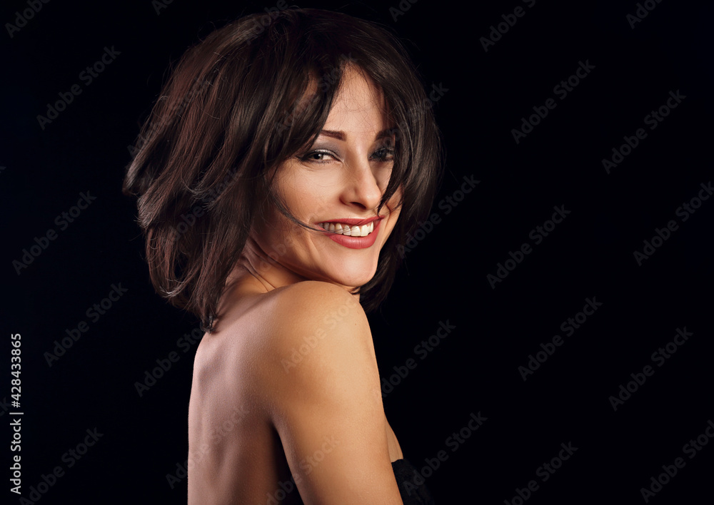 Happy laughing bright makeup woman shaking her black short hair on black background. Closeup portrait Happy laughing bright makeup woman shaking her black short hair on black background. Closeup portrait
