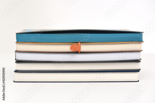 A stack of paper books or diaries for writing on a white background
