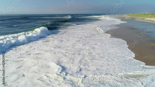 static shot on ocean with sun glaring off the water 