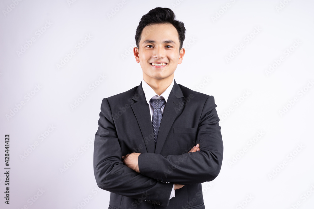 Image of young Asian businessman wearing suit on white background Image of young Asian businessman wearing suit on white background