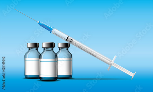 Vaccine bottles with clean label and syringe on blue background