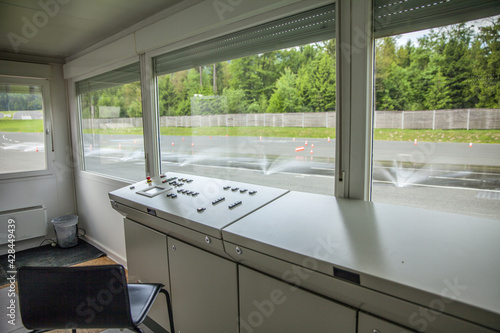 Control cabinet in a safe driving center with a water road sprinkler outside photo