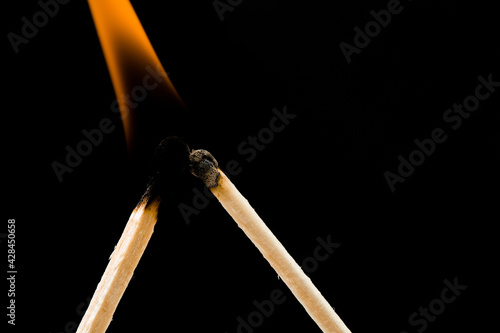 burning match on black background 