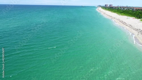 wide shot on ocean and man parasailing