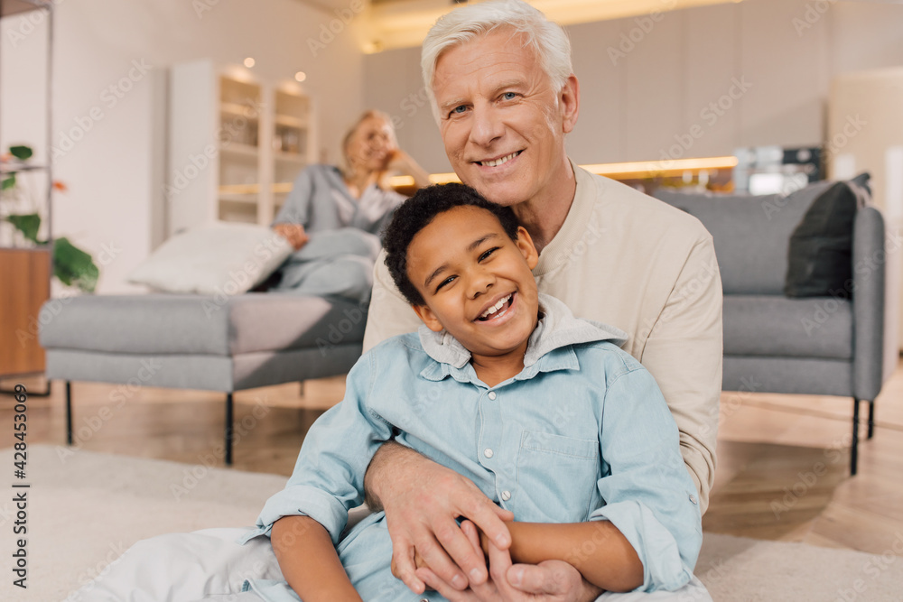 Father embracing his multiracial son with tenderness and posing Father embracing his multiracial son with tenderness and posing