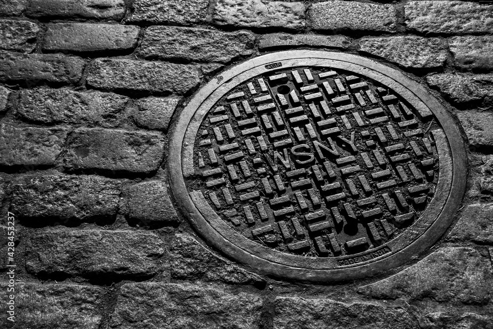 NYC Manhole Cover on Brick Street 