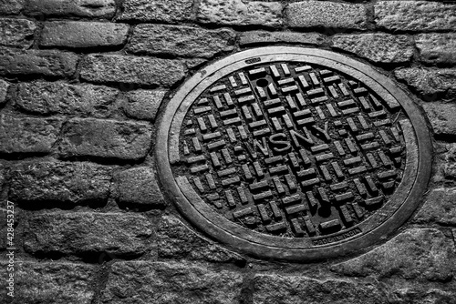 NYC Manhole Cover on Brick Street 