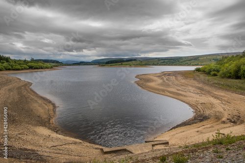 Low water level on a UK reservoir. Water shortage in drought conditions