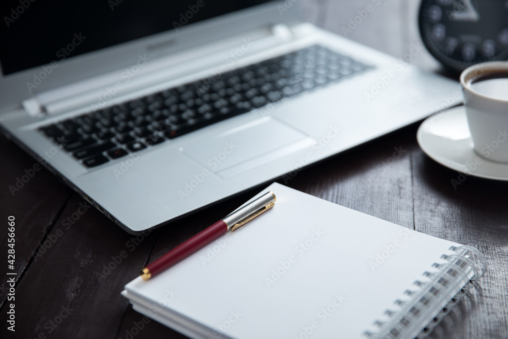 pen on notepad with keyboard and coffee