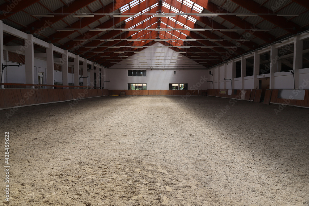 Obraz premium Photo of an empty indoor riding hall for horses and riders