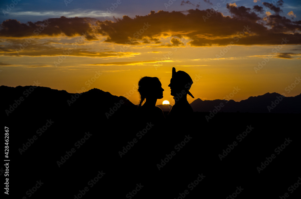 Couple enjoying sunset in the desert in Namibia