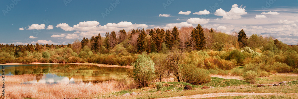 Fototapeta premium Wide angle large panoramic view on wooded hill and small lake at sunny day