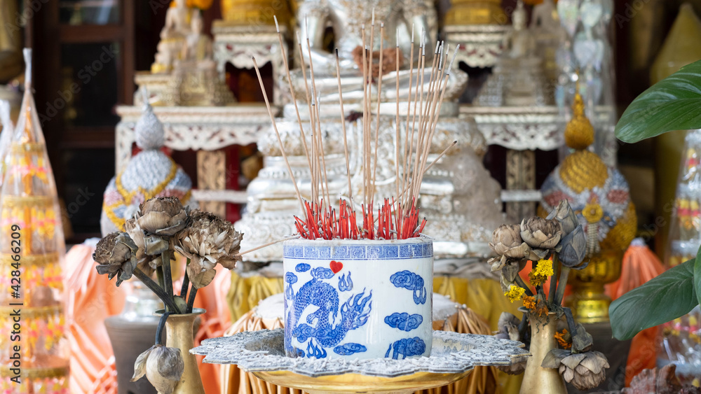 Incense that is lit to worship the Buddha in a censer Incense that is lit to worship the Buddha in a censer