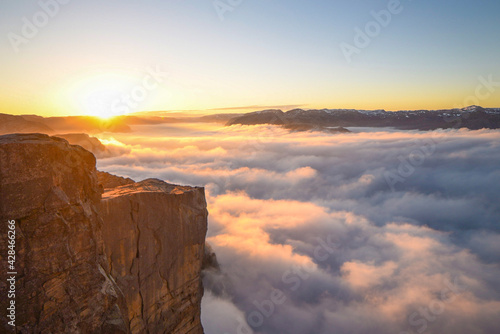 Pulpit Rock mountain sunrise over cloud covered ocean fjord © Jorn Tveten