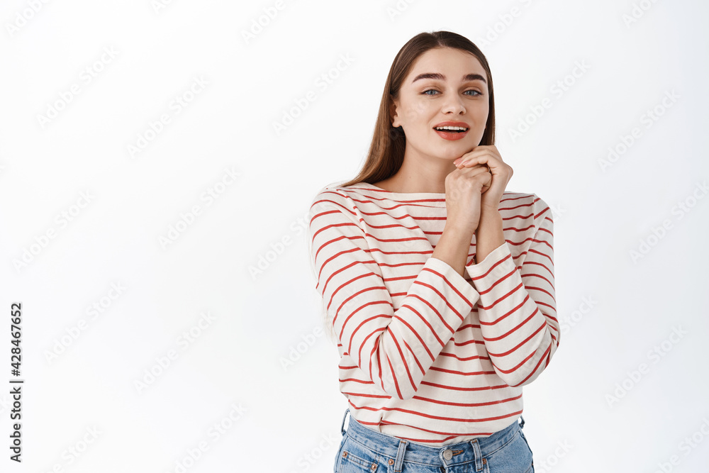 Girl admire something beautiful, look with affection and tenderness, sighing with touched fascinated expression, gazing at camera romantic, standing over white background Girl admire something beautiful, look with affection and tenderness, sighing with touched fascinated expression, gazing at camera romantic, standing over white background
