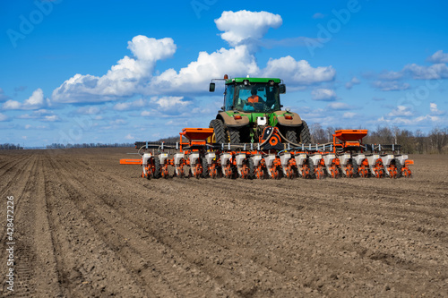 Wallpaper Mural tractor with seeder in the field in early spring Torontodigital.ca