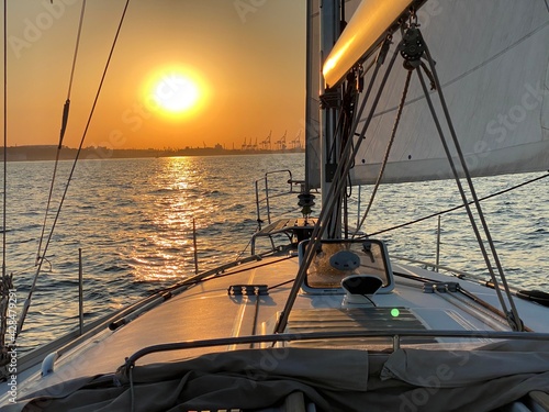 Fototapeta Naklejka Na Ścianę i Meble -  Sunset in the harbor. Sunset on the sea. Yacht at sunset. 