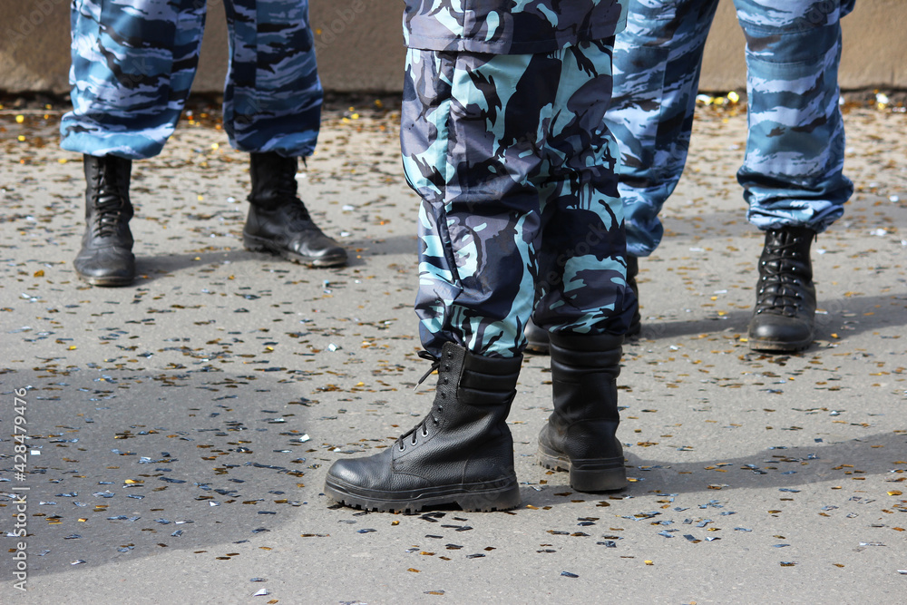 special police brigade protects the city from riots during the holiday. legs in overalls and boots. special police brigade protects the city from riots during the holiday. legs in overalls and boots.