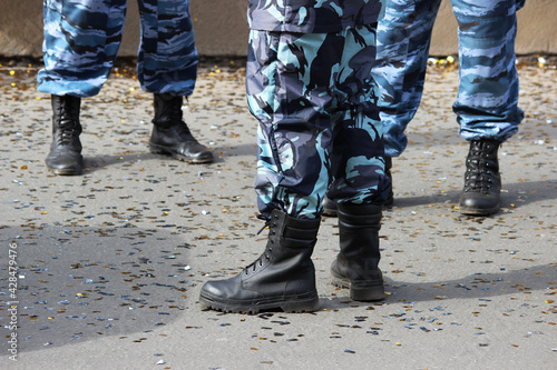 special police brigade protects the city from riots during the holiday. legs in overalls and boots.