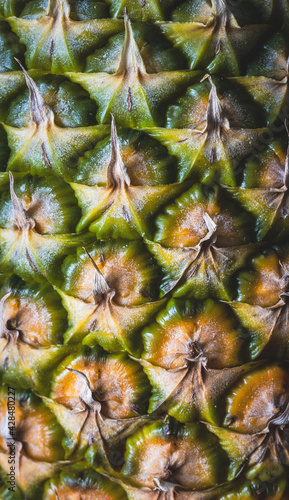 Close up image of a pineapple, showing the texture of the rough skin