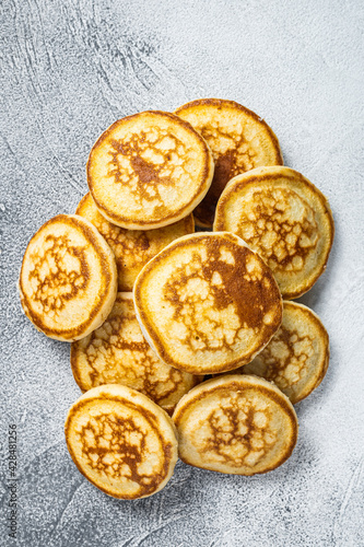 Stack of buttered pancakes on a kitchen table. White background. Top View