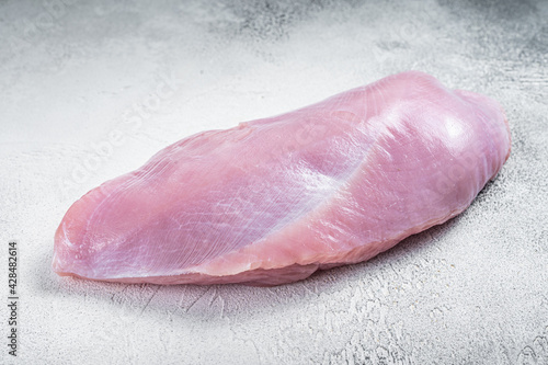 Raw whole big turkey breast fillet. White background. Top View