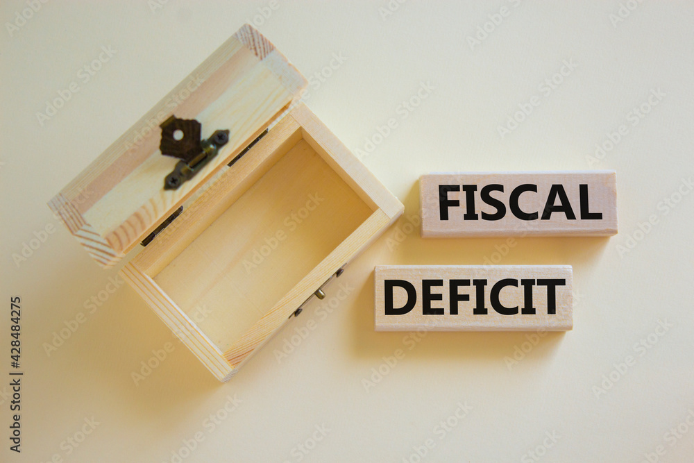 Fiscal deficit symbol. Concept words 'fiscal deficit' on blocks on a beautiful white background, small empthy chest. Business and fiscal deficit concept, copy space. Fiscal deficit symbol. Concept words 'fiscal deficit' on blocks on a beautiful white background, small empthy chest. Business and fiscal deficit concept, copy space.