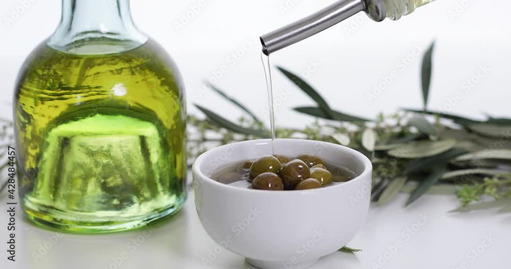 olive oil and olives over white table olive oil and olives over white table