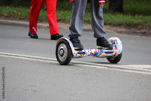 the guy rides on the road on a two-wheeled electric scooter without a handle: a gyro, a hoverboard, a segway