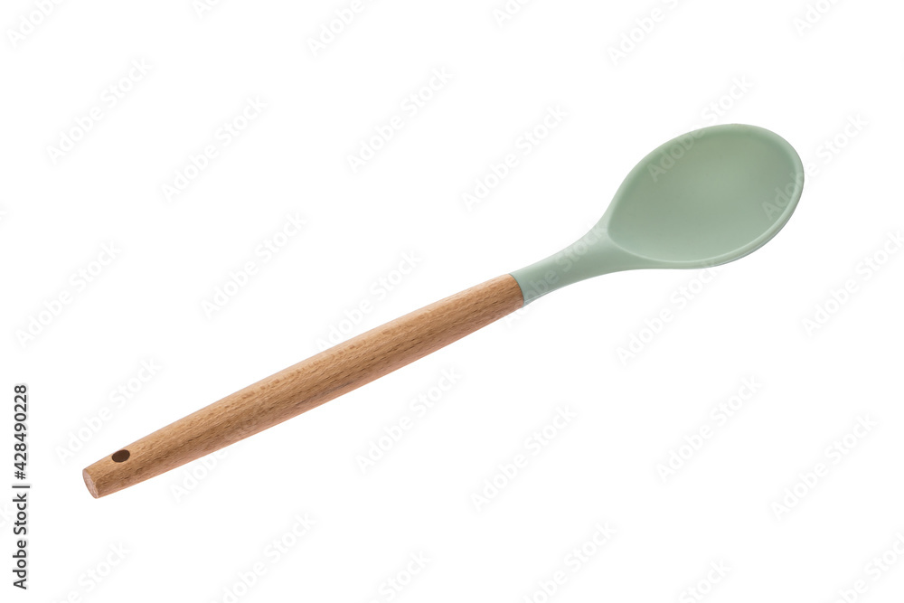 Kitchen tool in the form of a spoon made of green plastic with a wooden handle for cooking Kitchen tool in the form of a spoon made of green plastic with a wooden handle for cooking