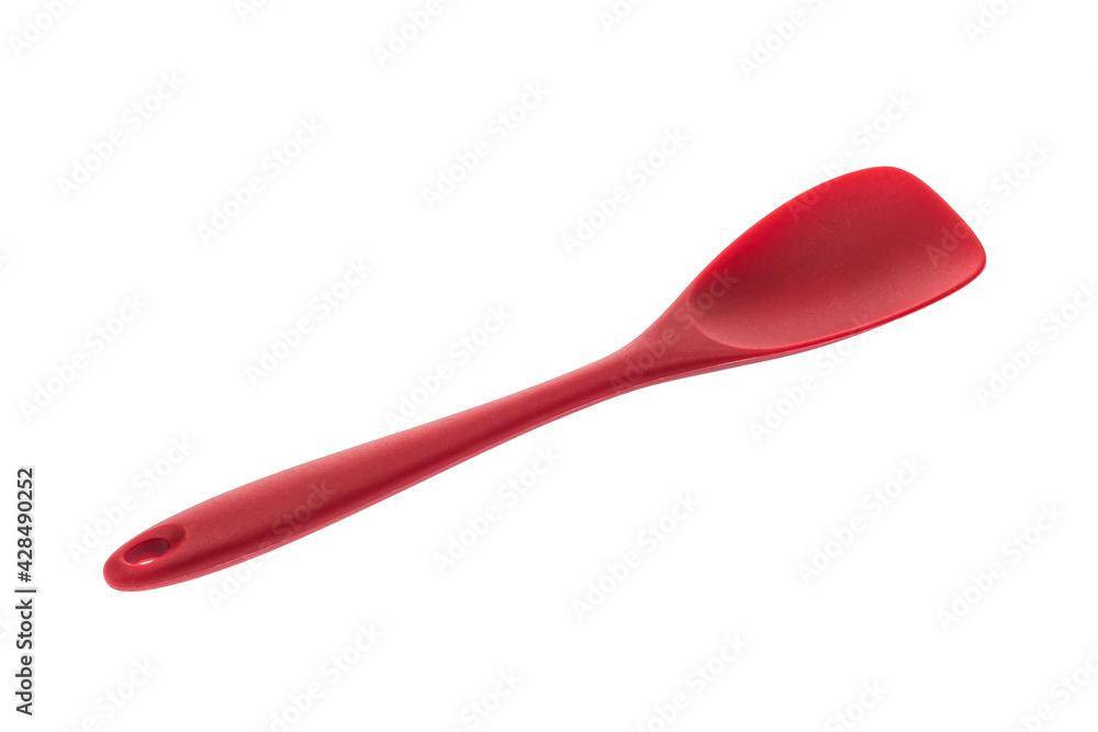 Kitchen tool in the form of a spatula made of red plastmass for cooking Kitchen tool in the form of a spatula made of red plastmass for cooking