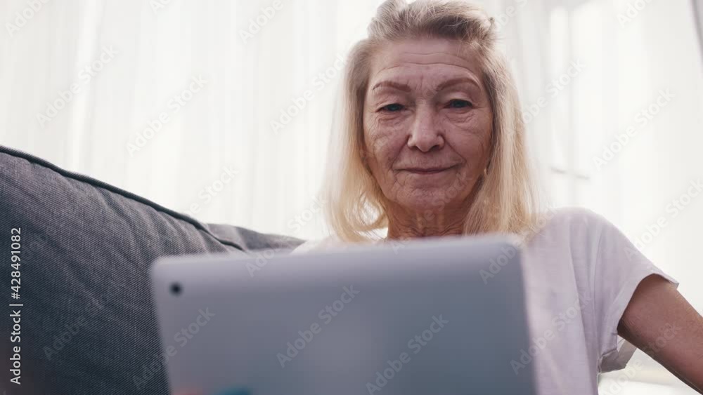 senior woman talking over the internet with family. High quality 4k footage senior woman talking over the internet with family. High quality 4k footage