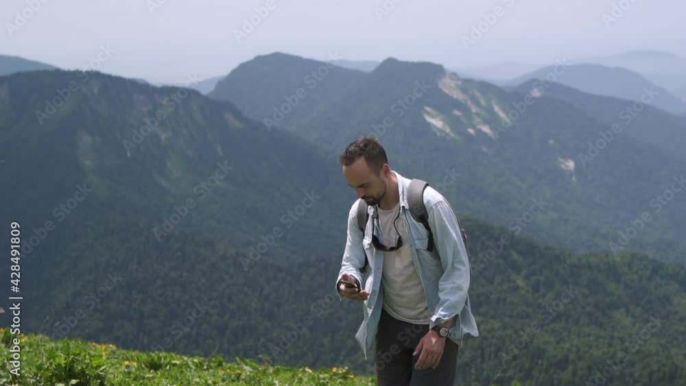 Tourist guide a man with a backpack studying the route on phone 
