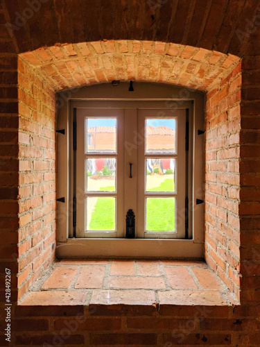 View from inside the thick brick walls of a castle.