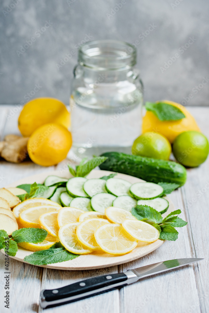 Detox refreshing sassy water with cucumber, ginger, mint and lemon in glasses, Healthy eating concept. Light background. Close-up. Body detoxication. Detox refreshing sassy water with cucumber, ginger, mint and lemon in glasses, Healthy eating concept. Light background. Close-up. Body detoxication.