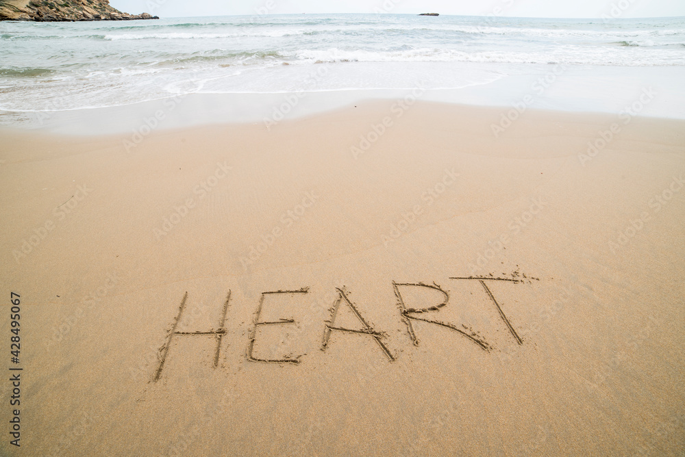 Fototapeta premium Words written on the sand on the beach