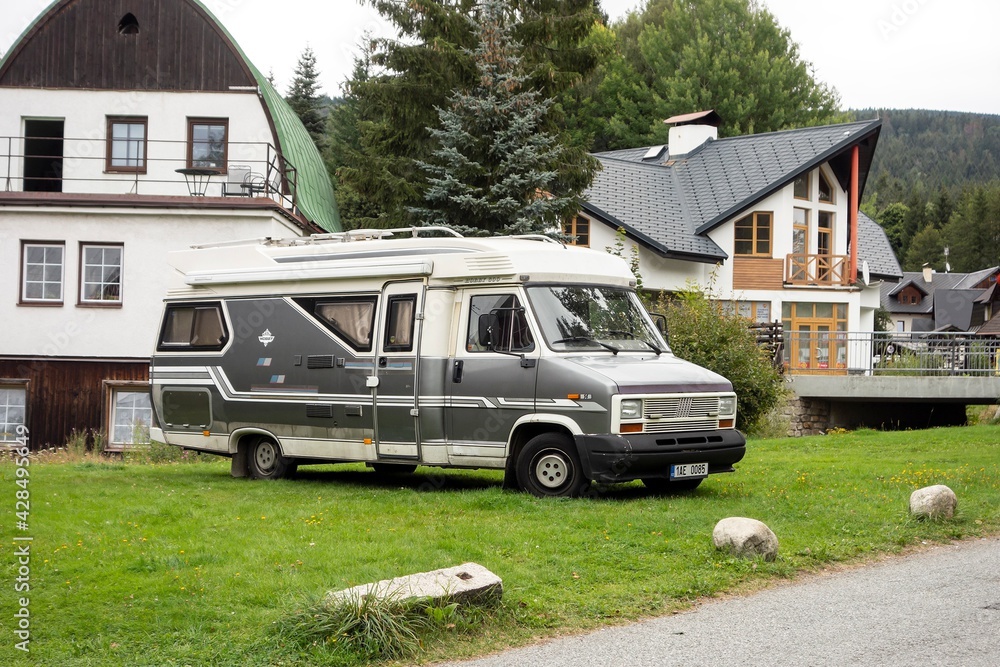 Vintage Fiat Ducato 14 Hobby 600 caravan car parked on a grass in front of  cottages Stock Photo | Adobe Stock