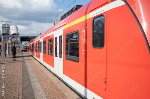 Regional train arrive and stop at outdoor platform railway station in Düsseldorf, Germany. photo
