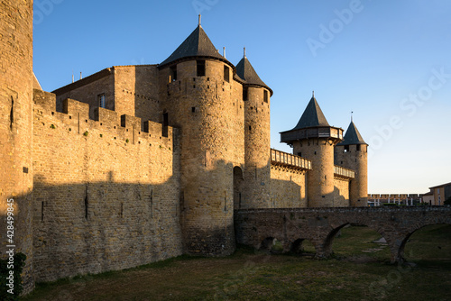 Dawn light illuminates the medieval castle walls located within the fortified city of Carcassonne, UNESCO World Heritage Site, France