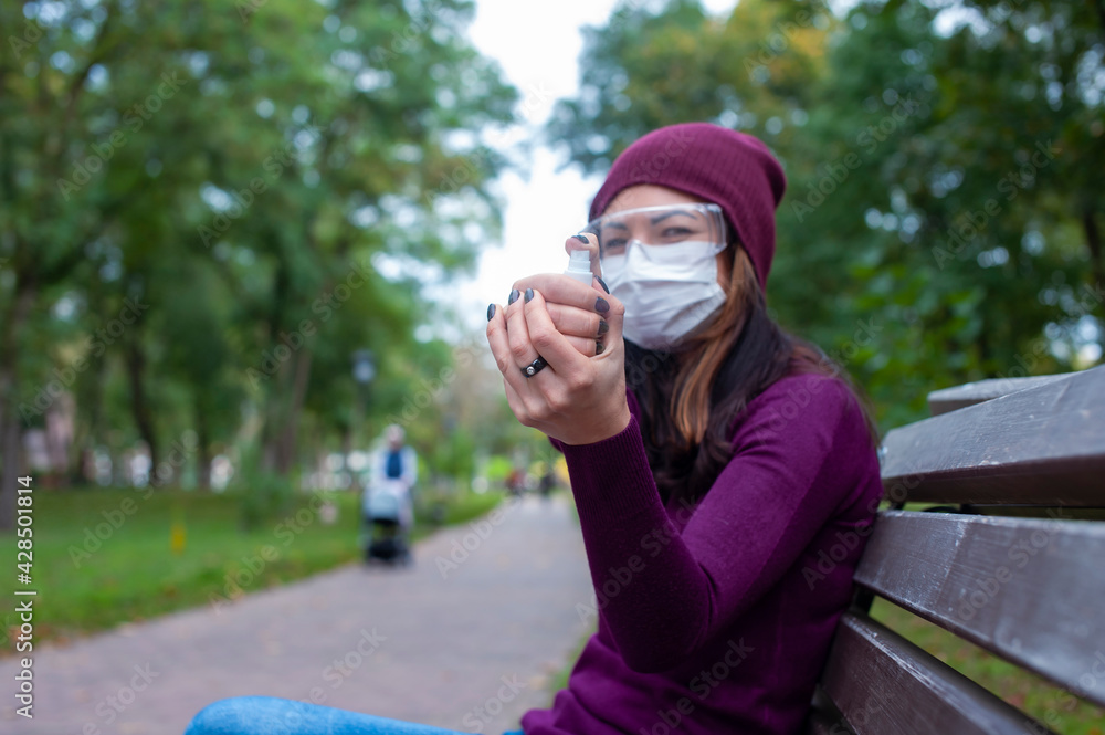 COVID-19 Concept. Woman in medical mask and goggles washing hands with alcohol gel sanitizer. Protection and prevention against coronavirus. COVID-19 Concept. Woman in medical mask and goggles washing hands with alcohol gel sanitizer. Protection and prevention against coronavirus.