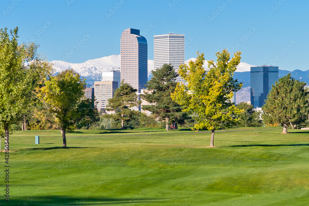 Denver City Golf Course with views of downtown Denver high rises and the mountains of the front range in the background, on a clear spring morning